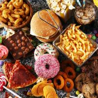 Image of many types of ultra-processed foods, including fries, hot dog, donuts, candy, soda, etc